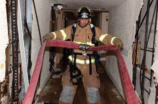 The 2 1⁄2-inch hose must remain in a "U" configuration on the floor below the fire because it will kink if it is configured to a "W" in a narrow hallway.